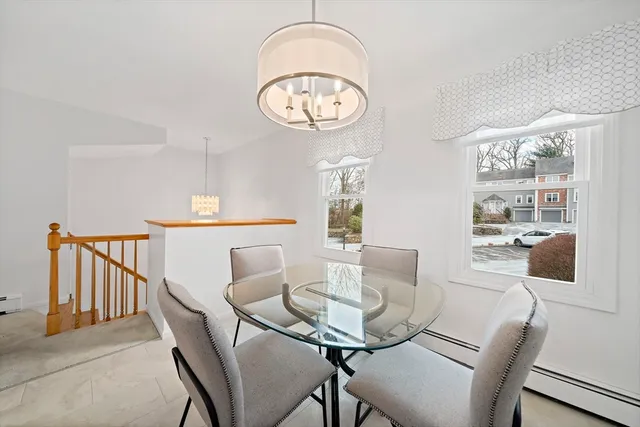 a view of a dining room with furniture and a large window