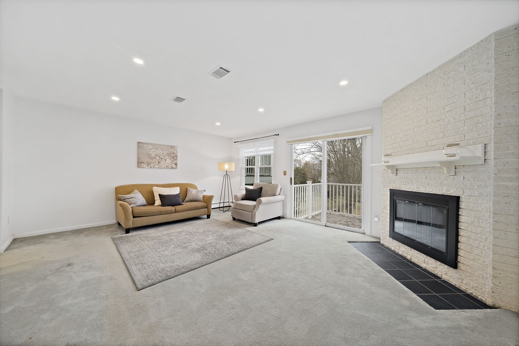 84 Walpole Street, Unit 3L Canton, MA 02021 - Photo 10 of 29 a living room with furniture and a fireplace