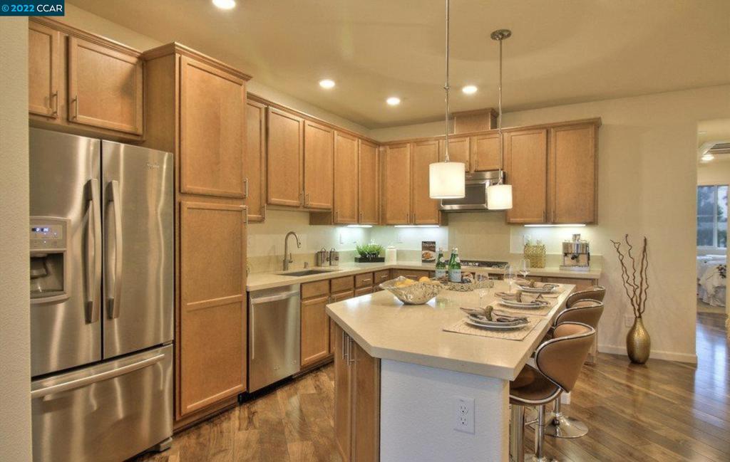 4708 Norris Canyon Road San Ramon, CA 94583 - Photo 2 of 6 a kitchen with a refrigerator a sink and cabinets