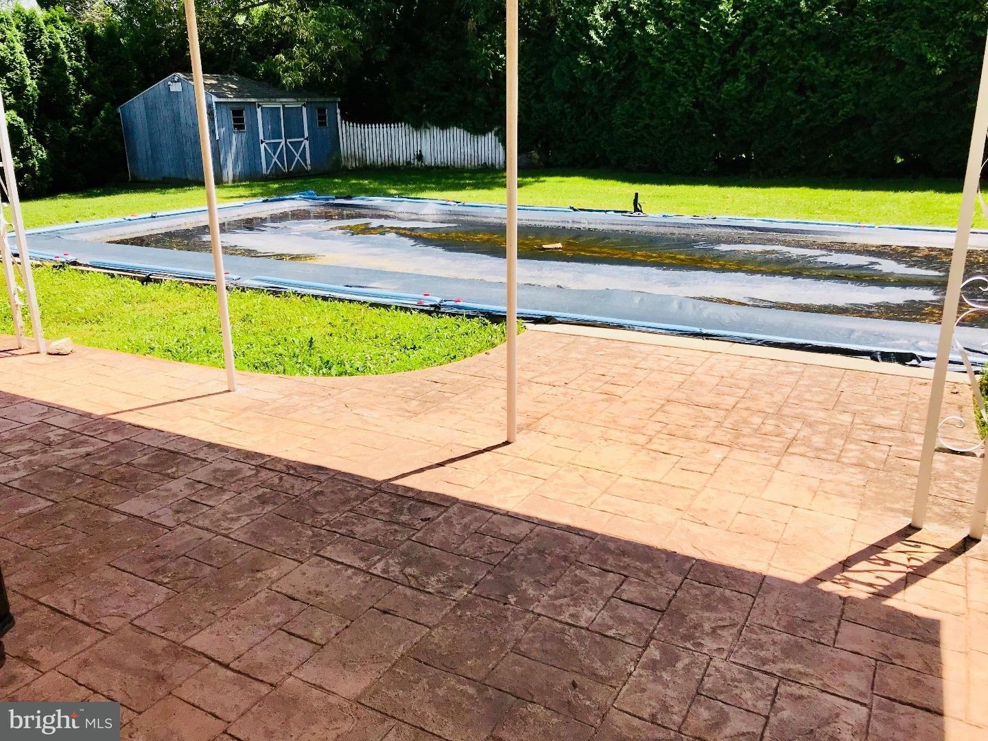 14 Annabeth Road Oley, PA 19547 - Photo 16 of 23 a view of a swimming pool with a lawn chairs under an umbrella
