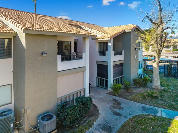 a front view of a house with plants