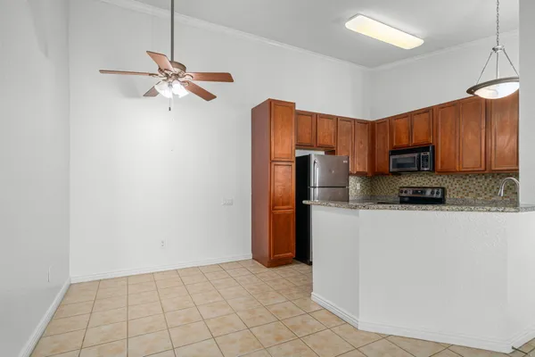 a kitchen with stainless steel appliances granite countertop a refrigerator a stove top oven a sink and dishwasher