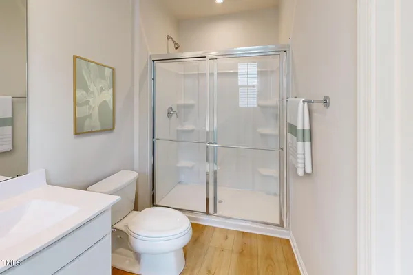 a bathroom with a toilet and a shower