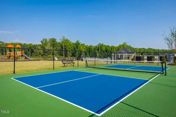 a view of tennis court with houses
