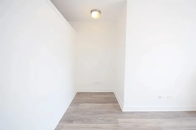 a view of a room with wooden floor