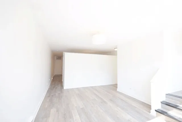 a view of a room with wooden floor