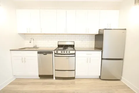 a kitchen with a refrigerator and a stove