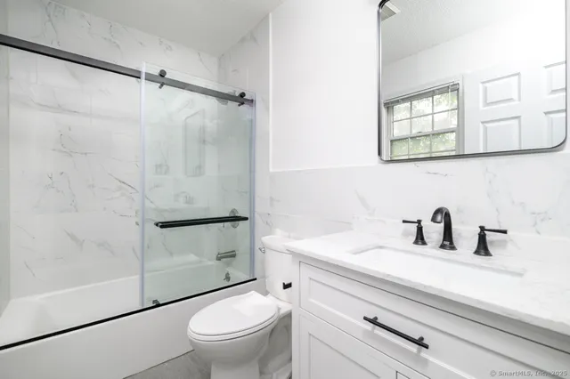 a bathroom with a sink toilet and shower