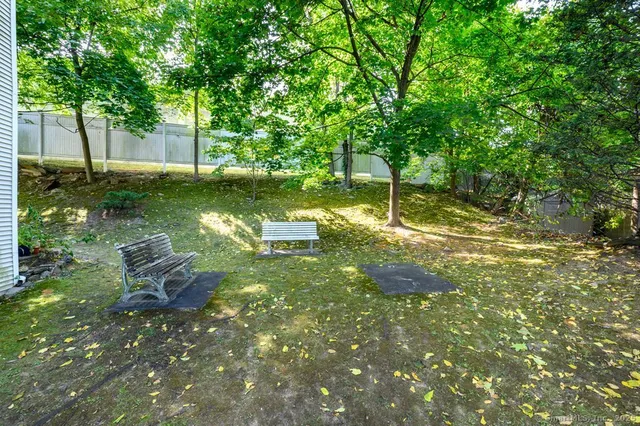 a backyard of a house with table and chairs