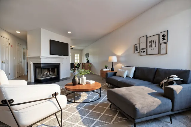 a living room with furniture a fireplace and a flat screen tv
