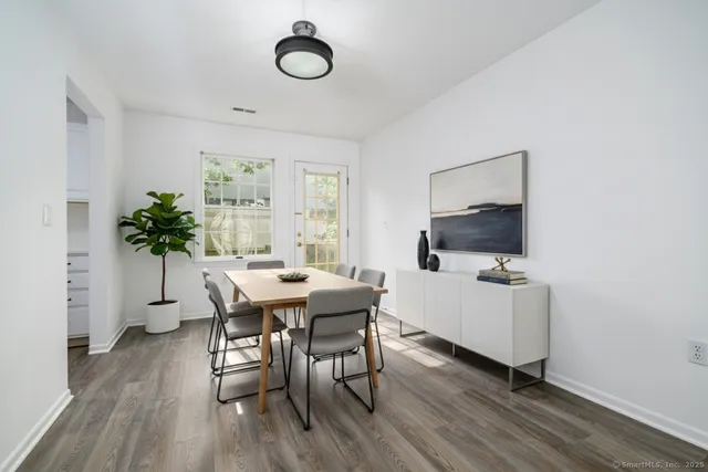 a view of a dining room with furniture window and wooden floor