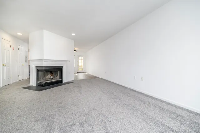 a view of empty room with a fireplace