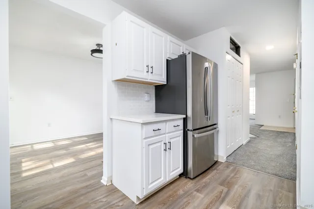 a kitchen with stainless steel appliances a refrigerator and a stove