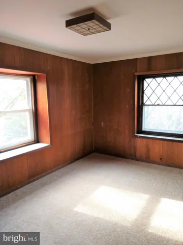 a view of an empty room with a cabinet
