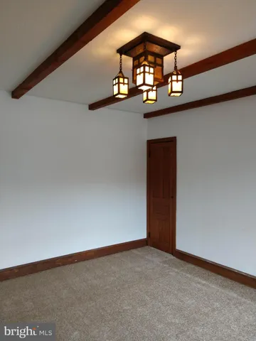 an empty room with a chandelier