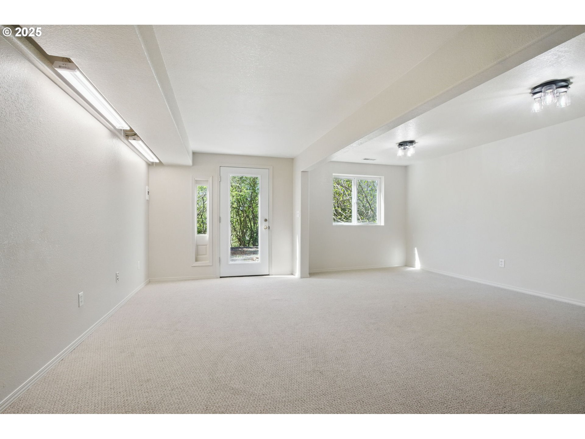 15960 Southwest Roshak Road Portland, OR 97224 - Photo 29 of 48 a view of a big room with windows and chandelier fan