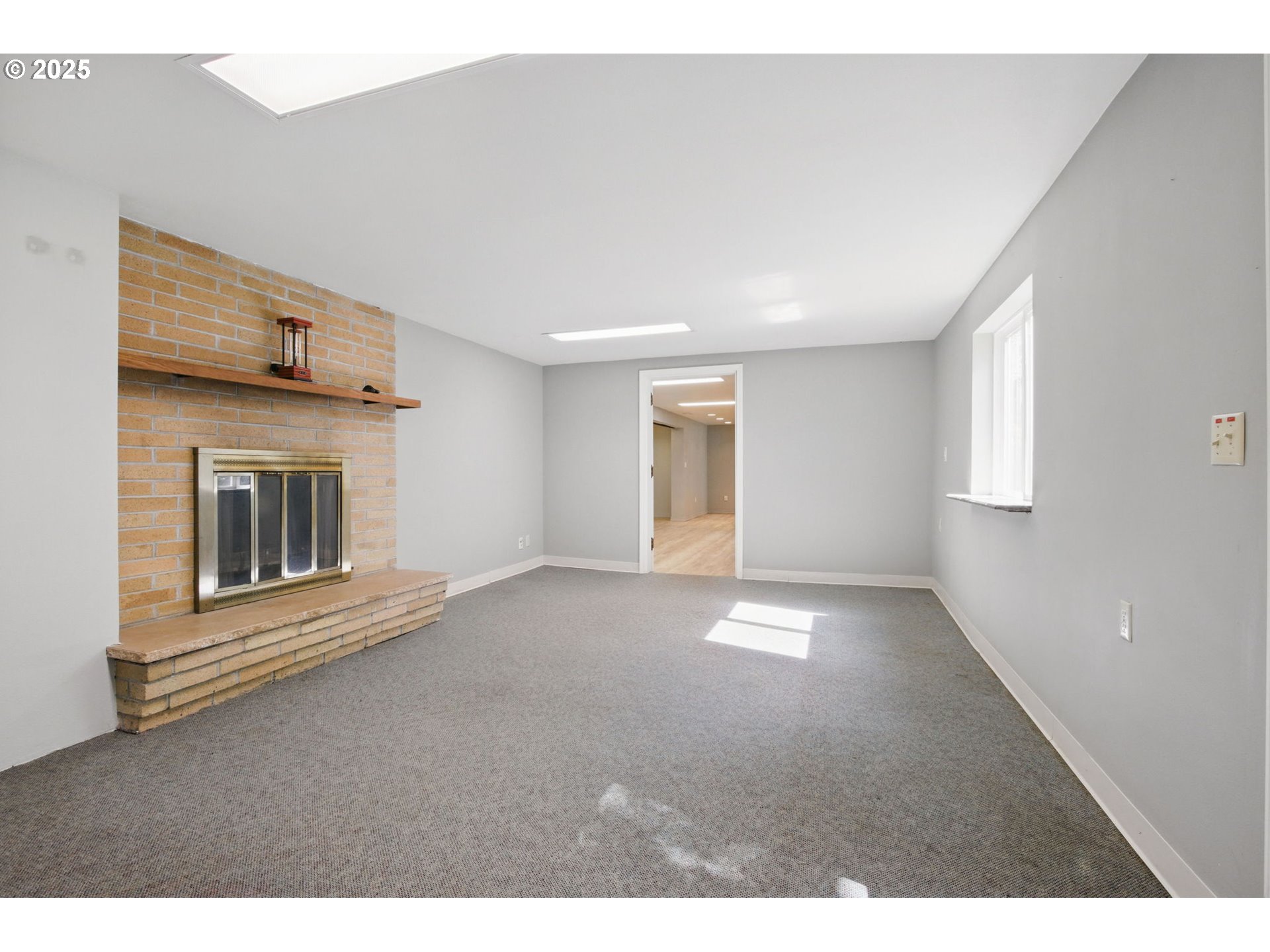 15960 Southwest Roshak Road Portland, OR 97224 - Photo 32 of 48 a view of an empty room with a fireplace and a window