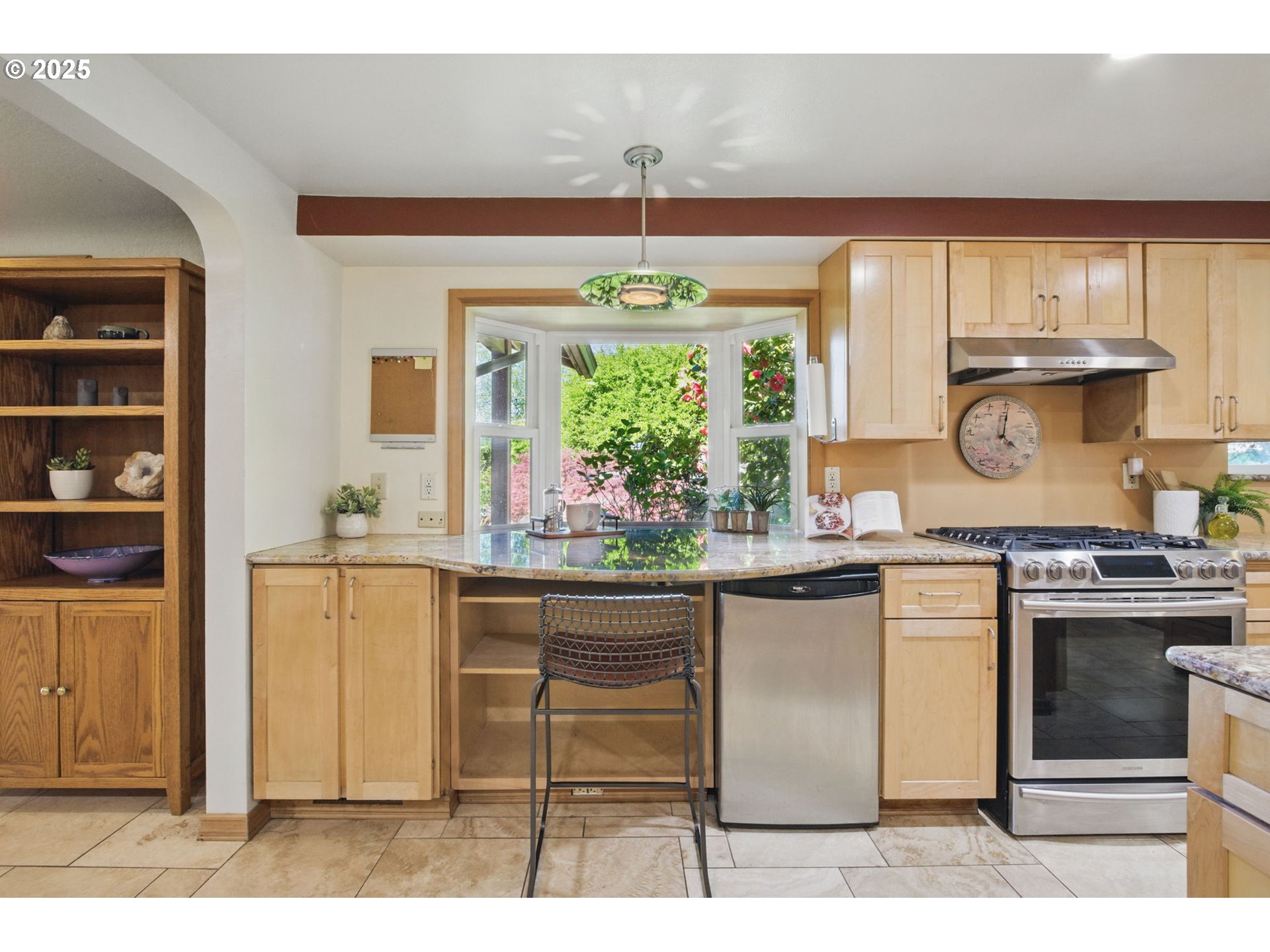 15960 Southwest Roshak Road Portland, OR 97224 - Photo 9 of 48 a kitchen with kitchen island granite countertop white cabinets and window