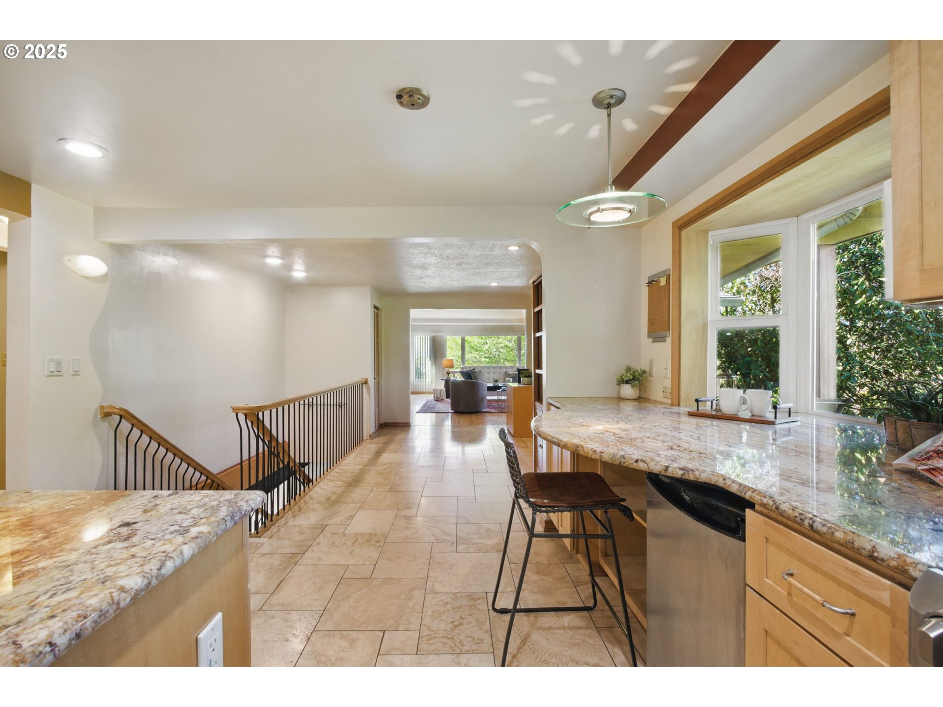 15960 Southwest Roshak Road Portland, OR 97224 - Photo 10 of 48 a dining hall with stainless steel appliances granite countertop a kitchen island a stove a sink a dining table and chairs with wooden floor