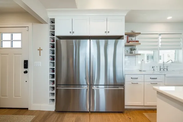 a kitchen with stainless steel appliances a refrigerator and cabinets