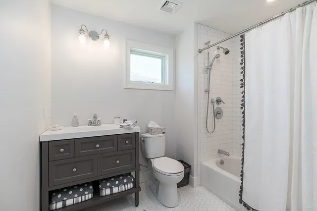 a bathroom with a toilet a sink and a mirror