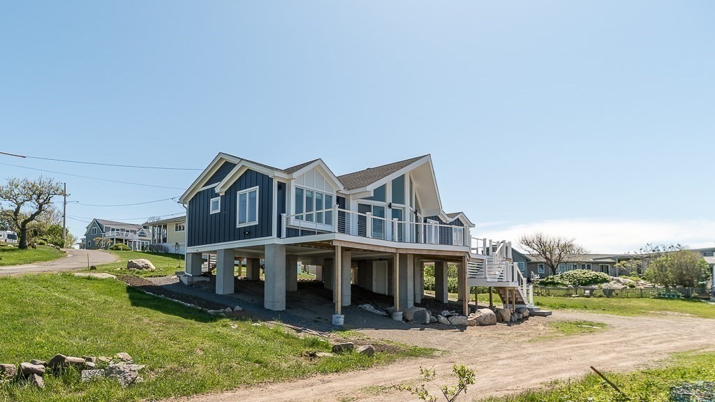 14 Sunset Point Road Gloucester, MA 01930 - Photo 29 of 40 a front view of a house with a yard table and chairs