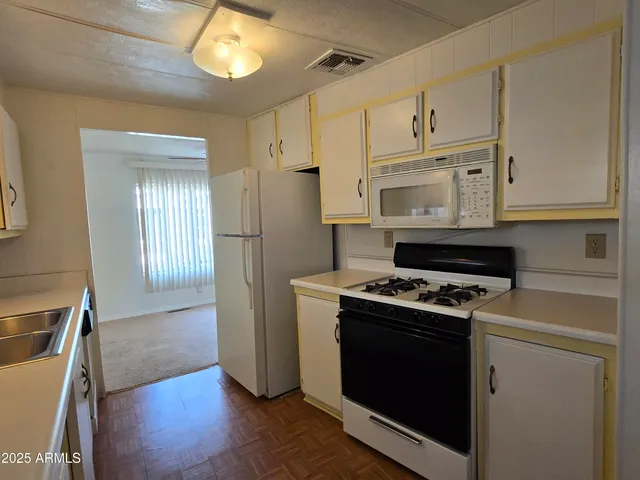 a kitchen with a sink stove and cabinets