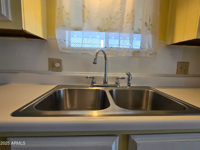 a kitchen with stainless steel appliances a refrigerator a stove and white cabinets