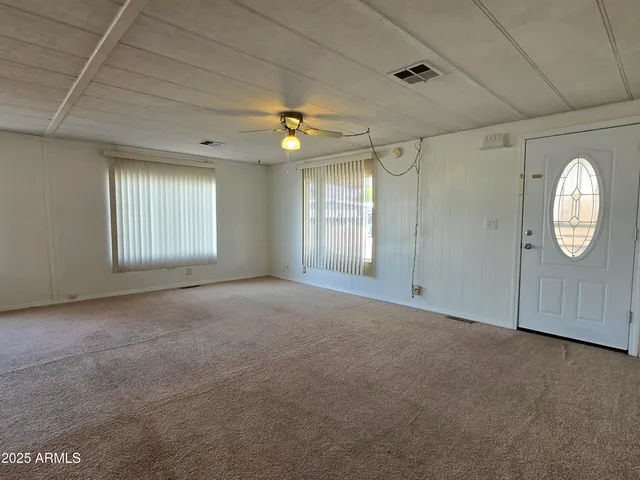 an empty room with windows and closet