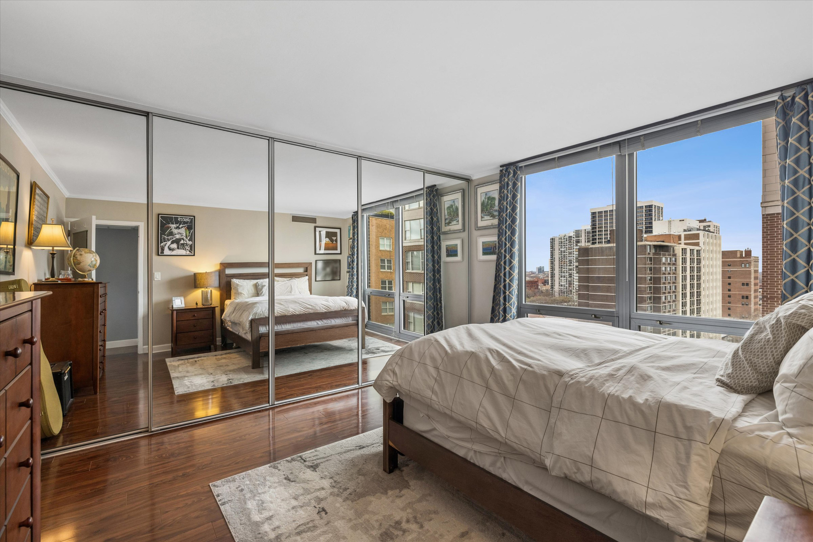 21 West Goethe Street, Unit 15A Chicago, IL 60610 - Photo 12 of 20 a bedroom with a large bed and a walk in closet