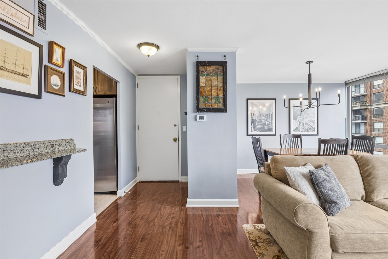 21 West Goethe Street, Unit 15A Chicago, IL 60610 - Photo 3 of 20 a living room with furniture and a wooden floor