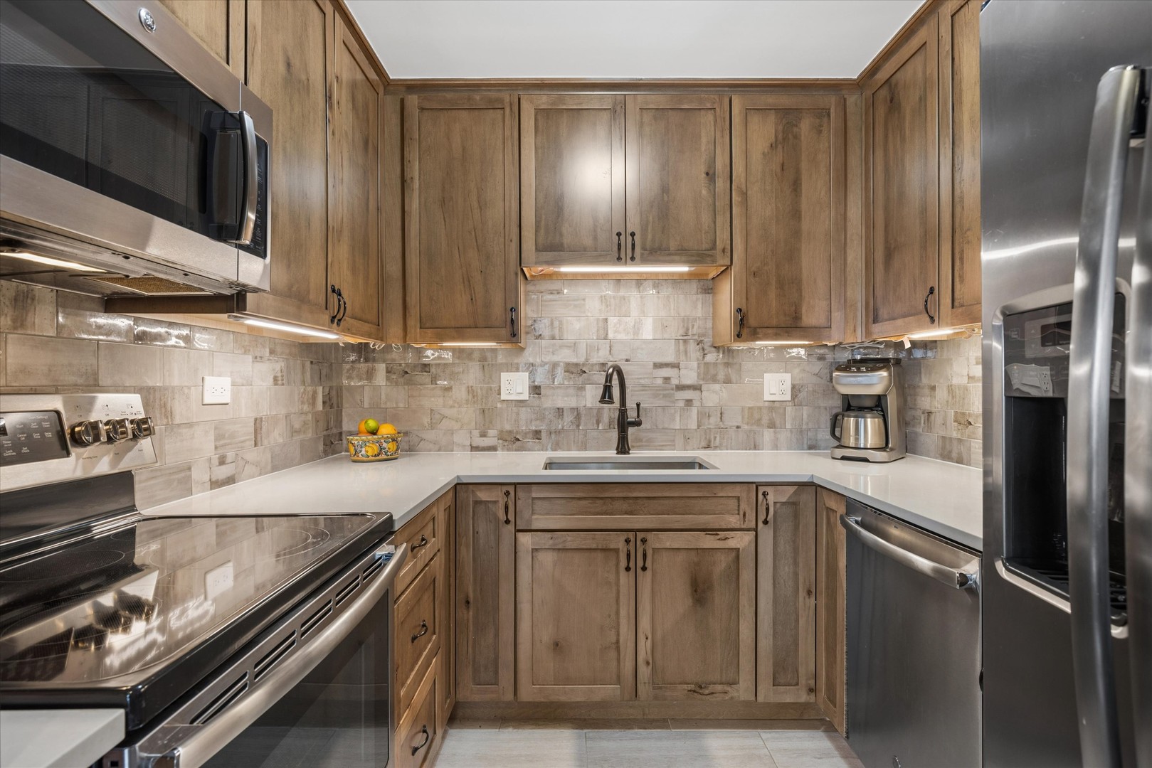 21 West Goethe Street, Unit 15A Chicago, IL 60610 - Photo 4 of 20 a kitchen with stainless steel appliances granite countertop a sink a stove and a refrigerator