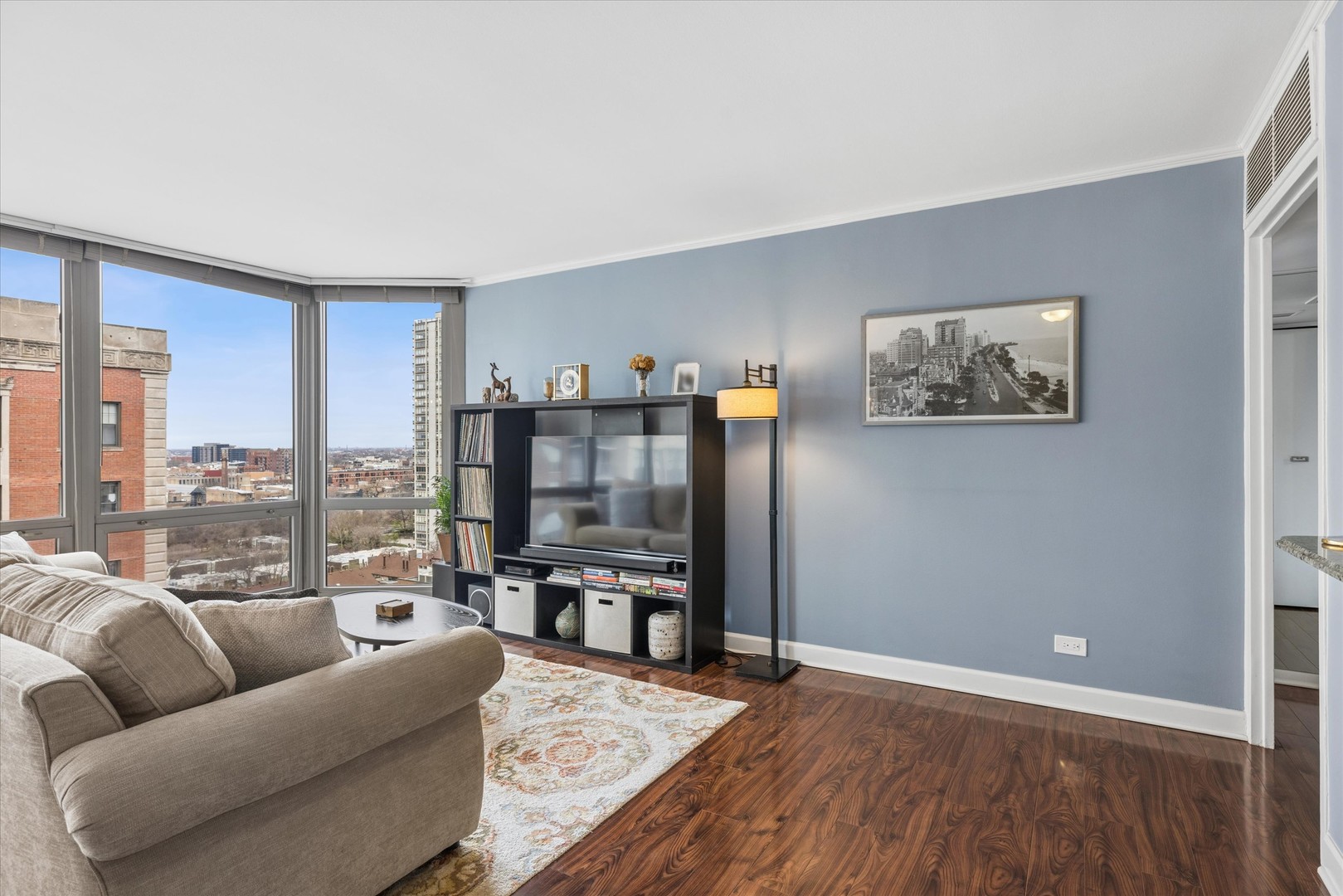21 West Goethe Street, Unit 15A Chicago, IL 60610 - Photo 5 of 20 a living room with furniture a flat screen tv and a floor to ceiling window