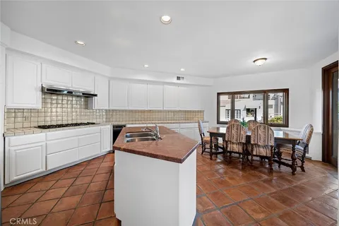 a kitchen with lots of counter top space and dining table