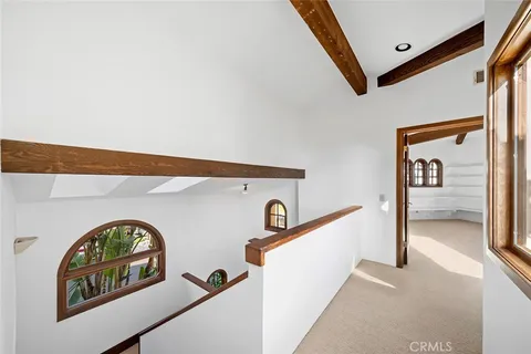 a spacious bedroom with a balcony a bed and a large window