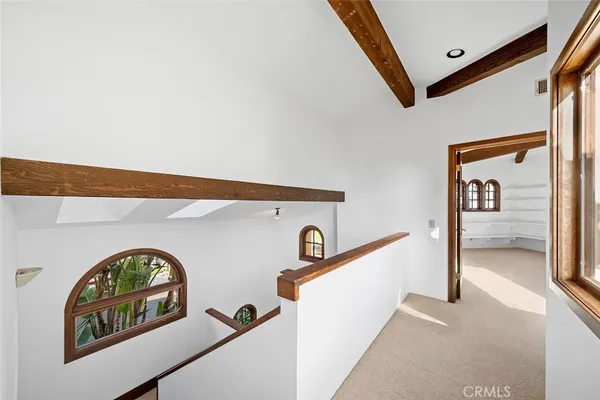 a spacious bedroom with a balcony a bed and a large window