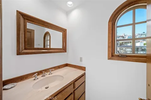 a backyard of a house with fountain table and chairs