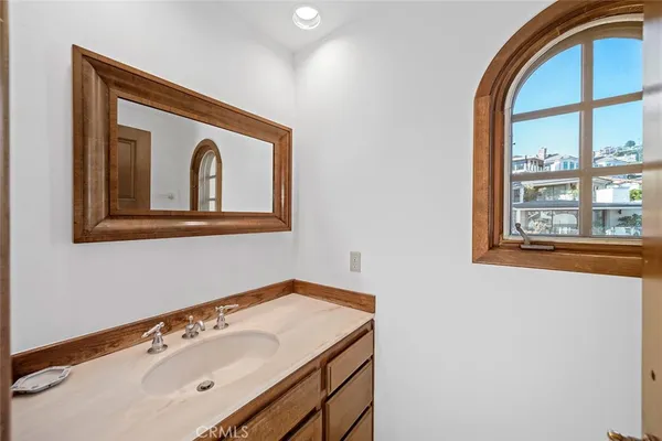 a backyard of a house with fountain table and chairs