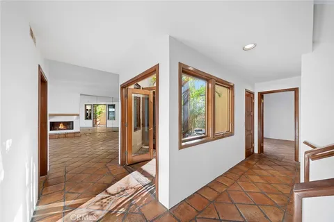 a view of a hallway with wooden floor and entryway