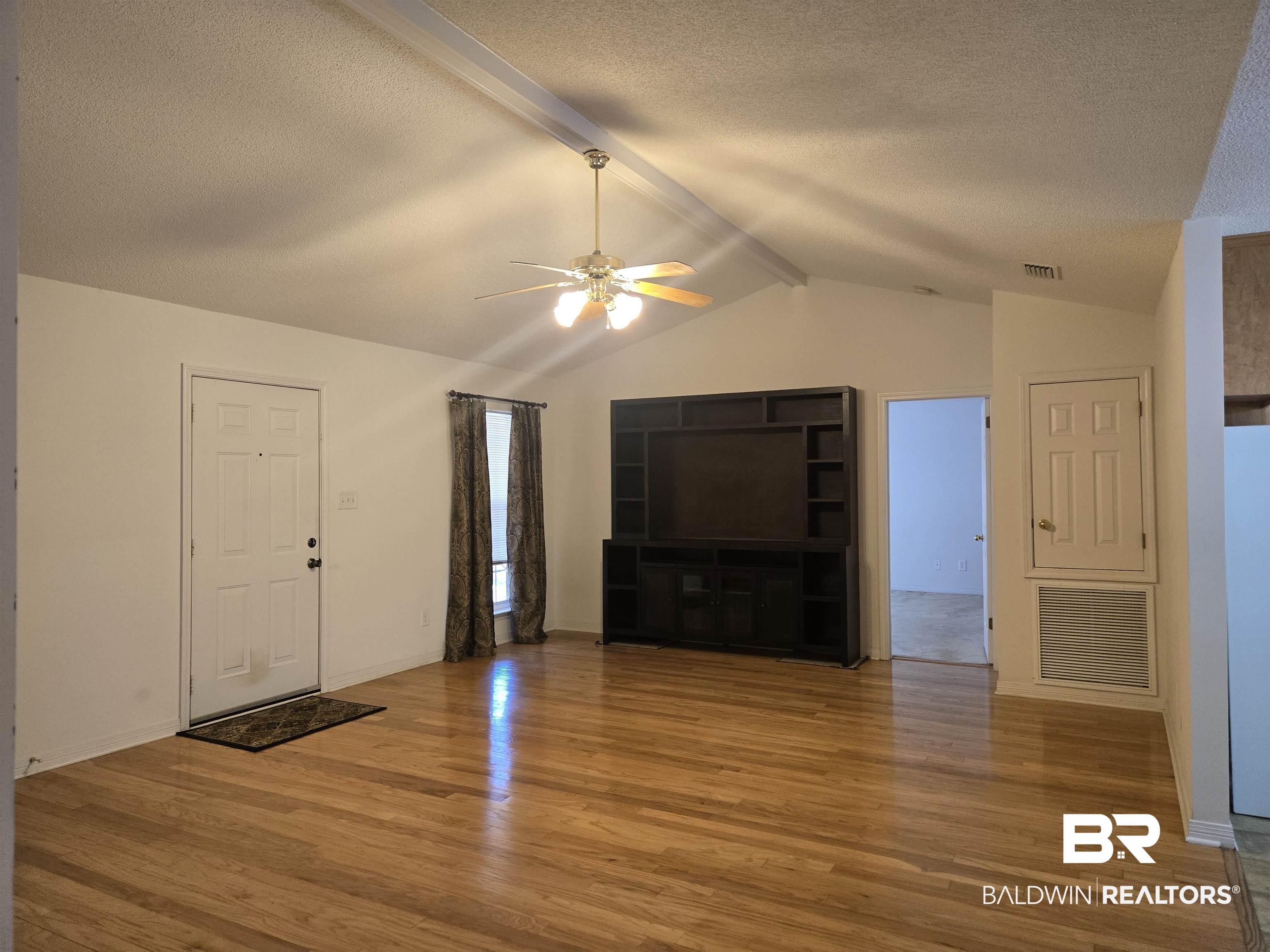 2554 Riverside Drive Mobile, AL 36605 - Photo 20 of 43 Unfurnished living room with light wood finished floors, ceiling fan, and a textured ceiling