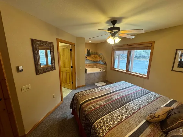 a bedroom with a bed and a chandelier