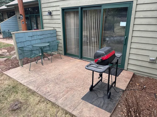 a backyard of a house with table and chairs