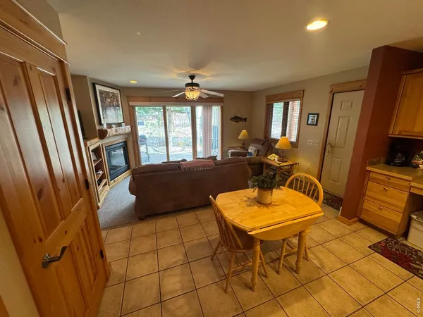 a living room with furniture a flat screen tv and a window