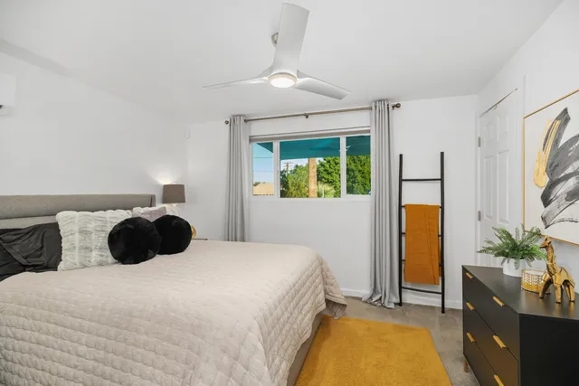 a bedroom with a bed and a potted plant