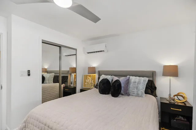 a bedroom with a bed and a lamp