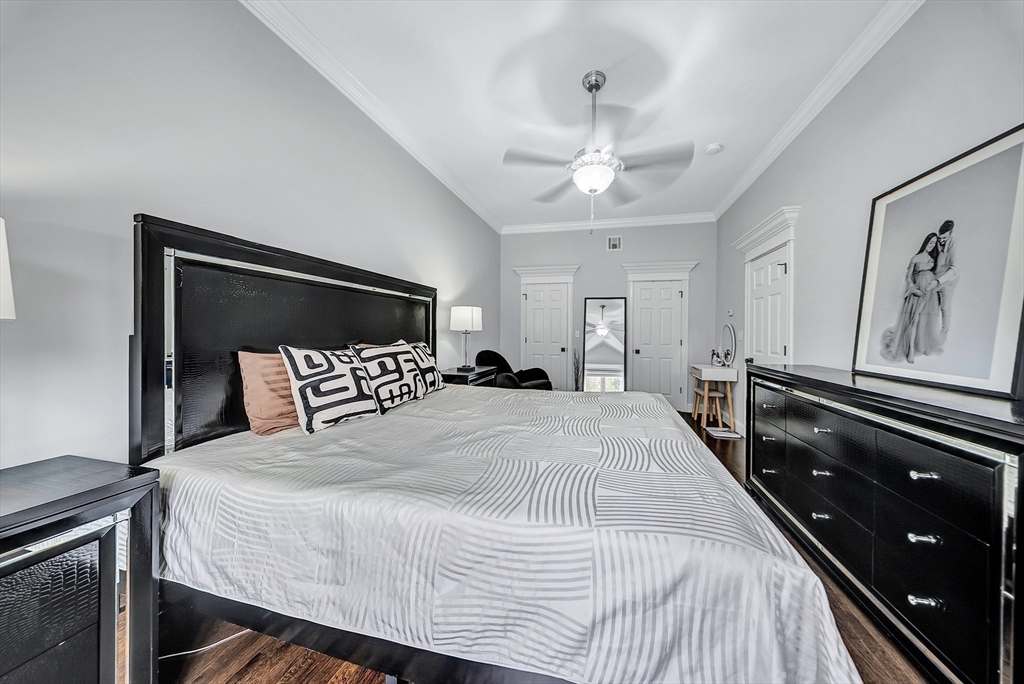 3 Stoddard Street Upton, MA 01568 - Photo 18 of 42 a bedroom with a large bed and a chandelier