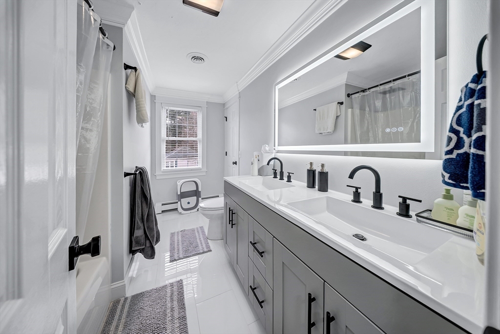 3 Stoddard Street Upton, MA 01568 - Photo 31 of 42 a bathroom with a double vanity sink a mirror and a shower
