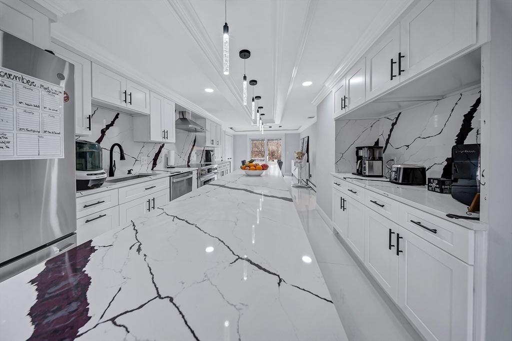 3 Stoddard Street Upton, MA 01568 - Photo 9 of 42 a kitchen with stainless steel appliances kitchen island granite countertop a sink and cabinets