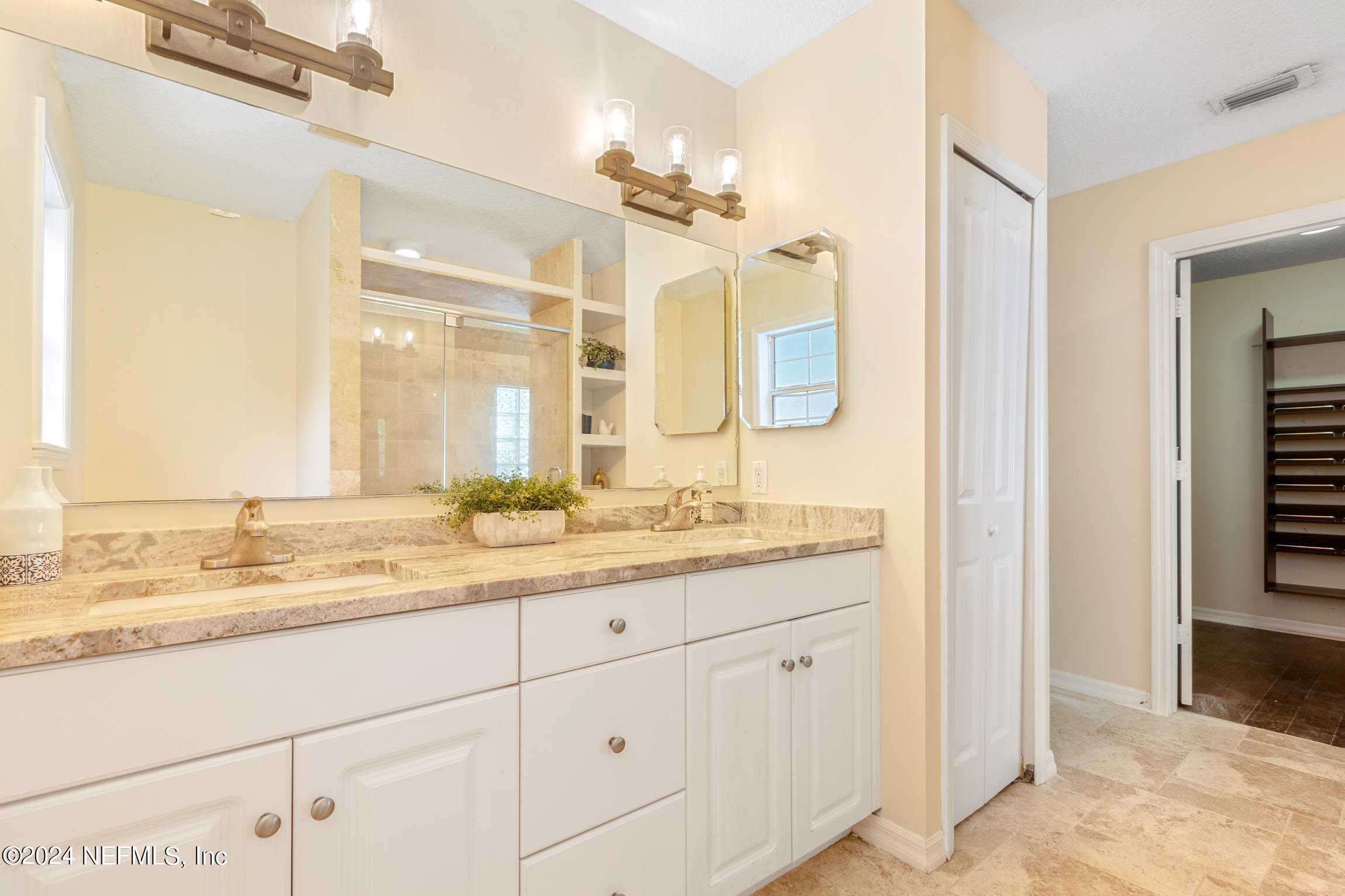 205 Shirley's Way St. Augustine, FL 32086 - Photo 19 of 57 a bathroom with a granite countertop sink mirror and
