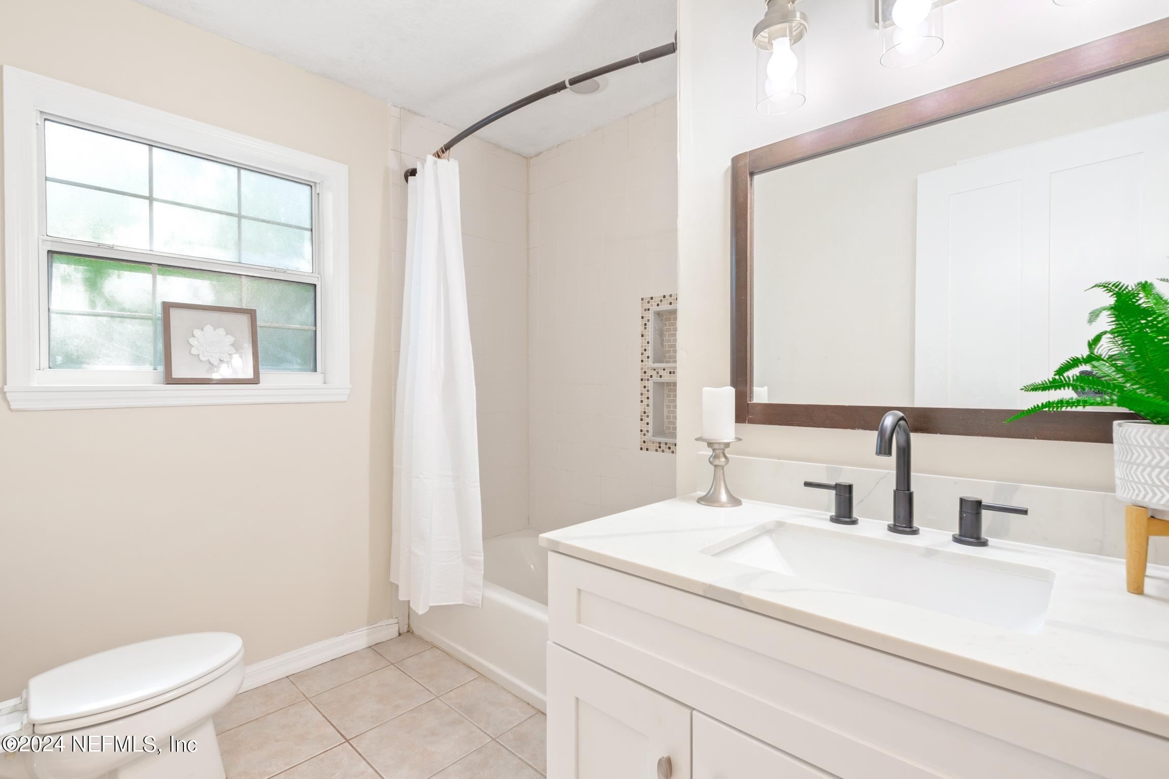 205 Shirley's Way St. Augustine, FL 32086 - Photo 27 of 57 a bathroom with a toilet a sink and a mirror